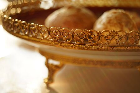 Gingerbread cookies in golden plate with a carved patterned sideの写真素材