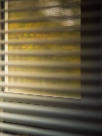 Metal shutters at the autumn window. Blurred closeup viewの写真素材