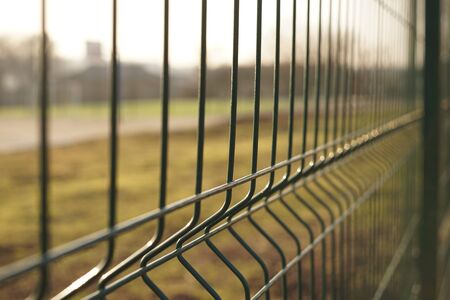 New green grid fence closeup, perspective view, selective focus