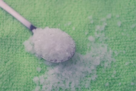 sea salt on the green table and in spoon.の写真素材