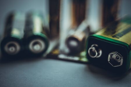 Different types of batteries on the dark table close-upの写真素材