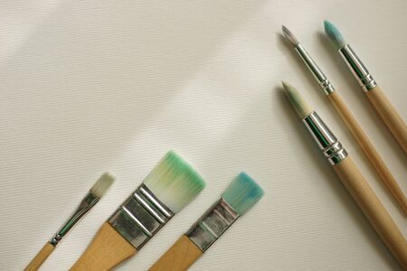 Used different brushes for painting on the white textured paper.の写真素材