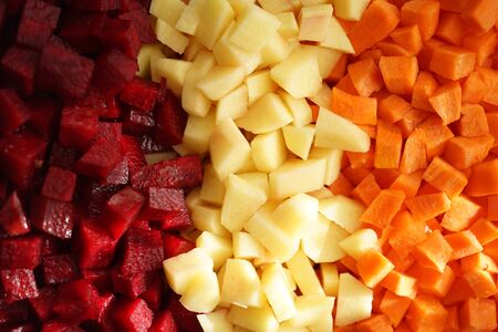 Square raw sliced beets, potatoes and carrots in three rows background. View from above. Healthy vegan food. The vinaigretteの写真素材