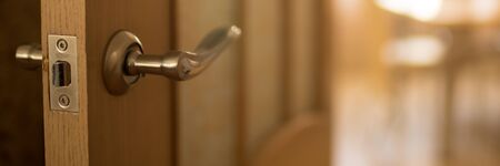 Door end with chrome handle in the sunny room.の写真素材