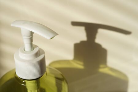 Green bottle of liquid soap with a white dispenserの写真素材