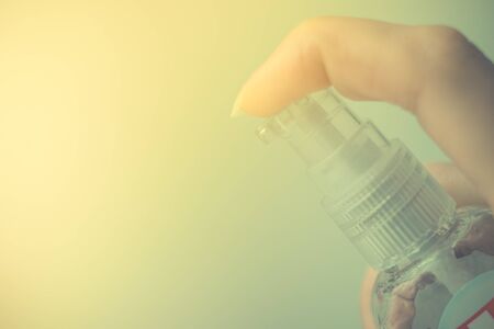Female hand use sanitizer gel, side view, copy spaceの写真素材