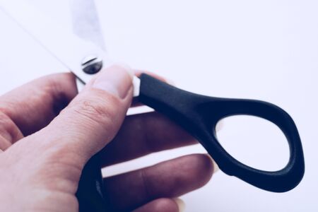 Female hand holds open stationery scissors close-up.5の写真素材