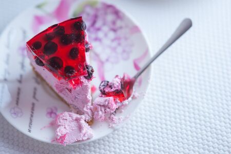 Currant cheesecake slice on a saucer with a spoon. Top viewの写真素材