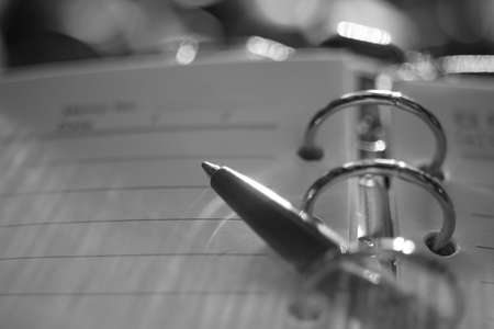 Ball pen in notebook. Macro photo, side view. BW photoの写真素材