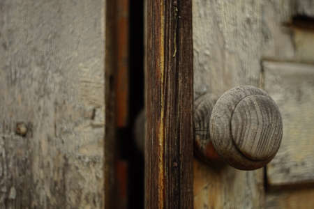 old brown wooden door with a round knob