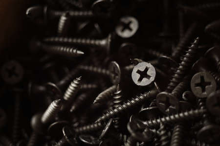 Pile of new black self-tapping screws closeup.の写真素材