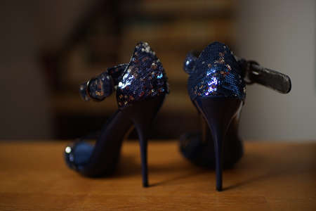 Summer sandals in blue sequins on a wooden floor.の写真素材