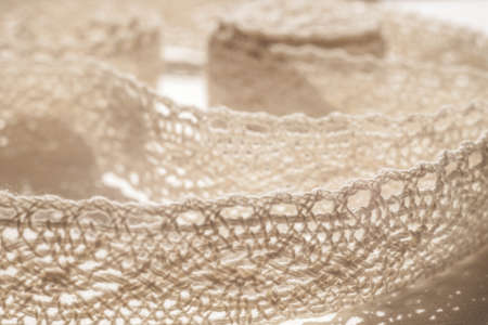 Natural delicate lace closeup on a white table.の写真素材