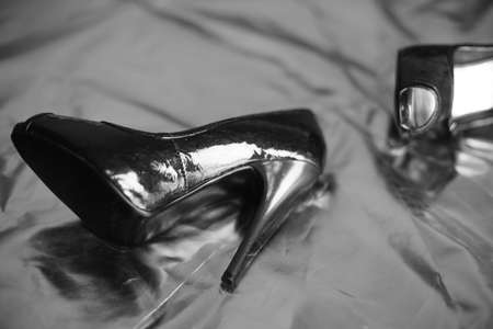 Shiny patent leather womens shoes in a retro classic style lie on a vinyl surface.の写真素材