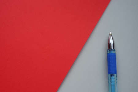 Blue ballpoint pen on gray with red paper, copy spaceの写真素材