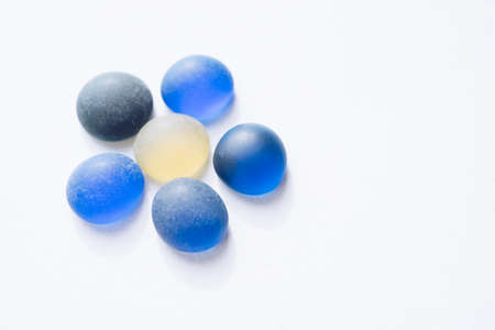 Blue flower made from glass stones on white paper. Copy space.の写真素材