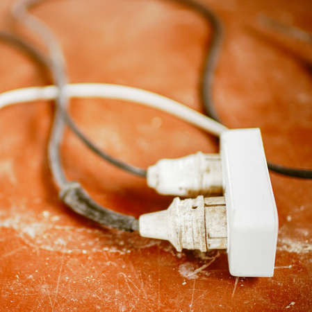 old homemade extension cord with wires on the floor.