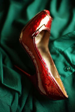 Female red heels in classic style on emerald blouse.の写真素材
