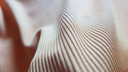 Beige cotton fabric with stripes, wavy background close up.の写真素材