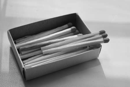 Cardboard box with matches on the table. BW photo.の写真素材