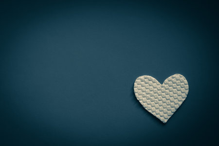 Fabric white heart on dark blue table. Art card. Copy spaceの写真素材