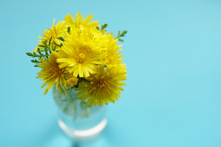 Yellow flowers bouquet on the blue table, art card, copy space.の写真素材