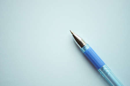 Blue ballpoint pen on pale blue paper.の写真素材