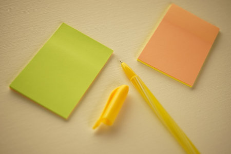 Yellow ballpoint pen and notes on beige paper.の写真素材