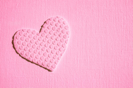 cute pink heart made of textured material on table, art card, copy spaceの写真素材