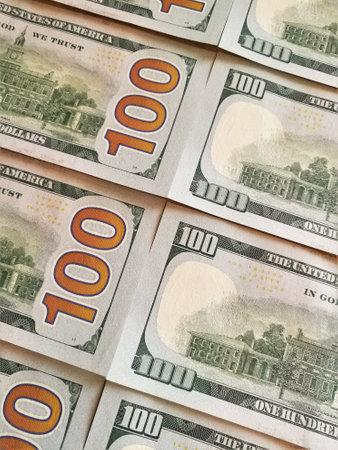 One hundred dollar bills on the tableの写真素材