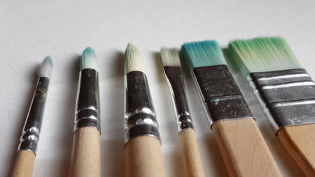 Used brushes for painting on the white textured paper.の写真素材