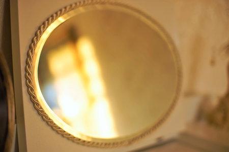 Oval mirror with a beautiful gold edging, dressing table decor, console mirror.の写真素材