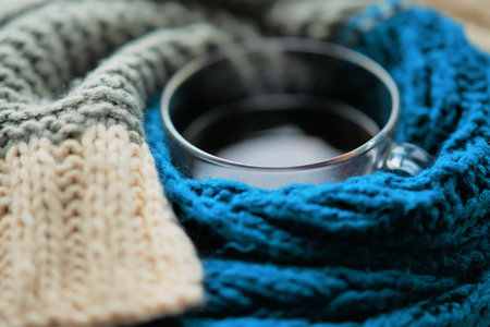 A cup of tea wrapped in a warm blue gray scarfの写真素材