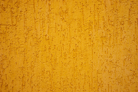 Background of yellow stone wall with drips.の写真素材