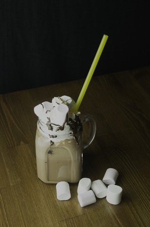 Candy flavoring with chocolate drinks in glass cups with handles placedの写真素材