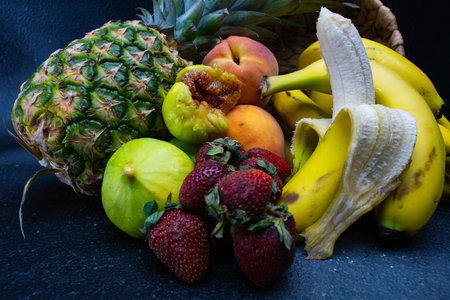 Fruits on a black background. banana, pineapple, strawberryの写真素材