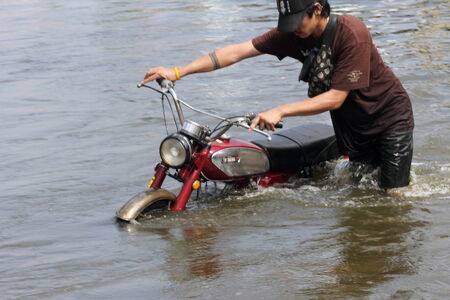 THAILAND Flood Bang Bua Thong City 20 10  2011 Moving their belongings to flee floods Pathum Thani Samkhok Rd  and Motorcycle  THAILAND のeditorial素材