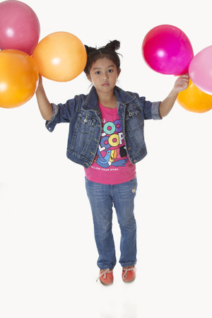 Child Denim shirt tied malformation playing with balloons.の写真素材