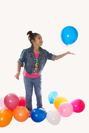 Child Denim shirt tied malformation playing with balloons.の写真素材