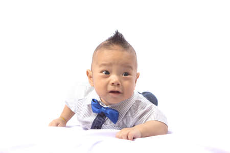 Children boy prone on the white background.の写真素材