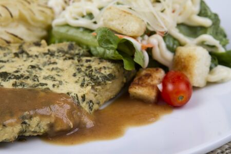 Pork steak served with mashed potatoes and salad.の写真素材