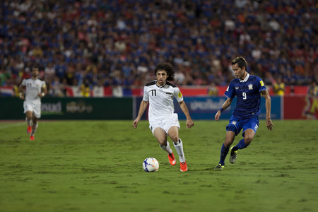 BANGKOK,THAILAND:September;2015:Sanrawat of Thailand and Human of IRAQ during The 2018 FIFA World Cup between THAILAND and IRAQ  at Rajamangala Stadium on September,08,2015inTHAILAND.のeditorial素材