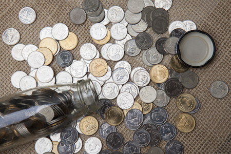 Coins stored in glass bottles.の写真素材