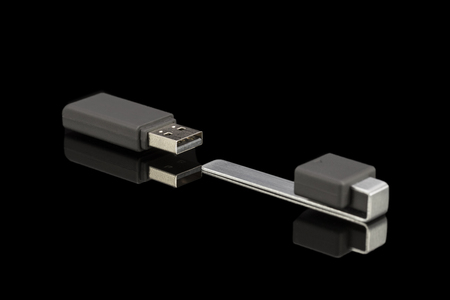 Gray pen drive isolated on black background