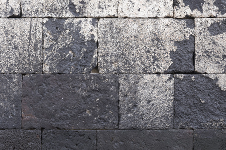 Old stone wall painted white and dirty. Front viewの写真素材