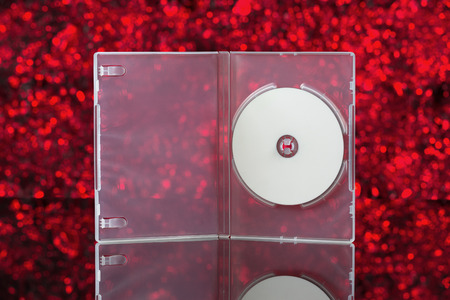 White CD in transparent box with red background. Front viewの写真素材