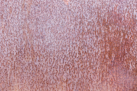 Rusty metal texture with red tones. Front view
