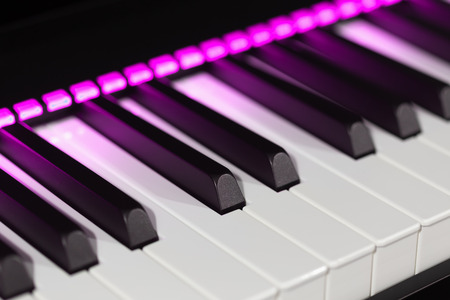 Electric piano detail with pink lights. Seen from one sideの写真素材