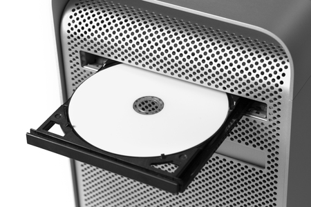 Inserting a white CD / DVD into a computer. Top viewの写真素材