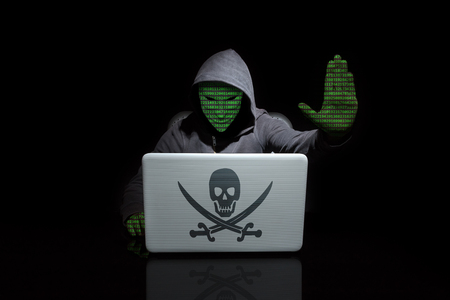 Anonymous with digit face with a stop hacking gesture. Dark backgroundの写真素材